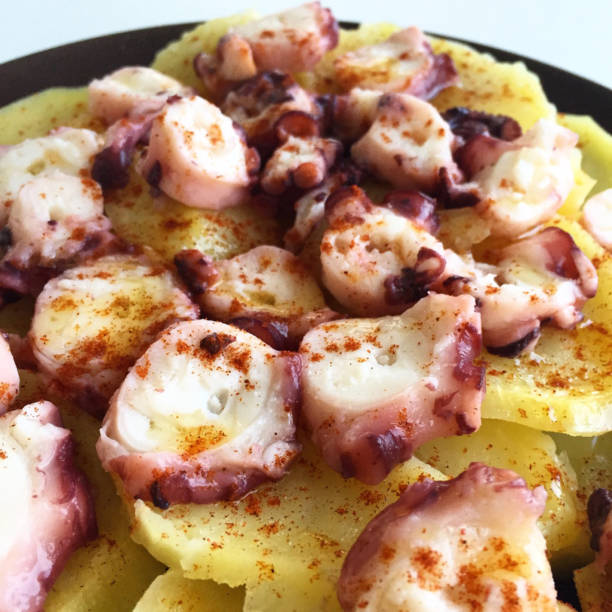 istock Spanish Octopus on a bed of potatoes close-up 646032618