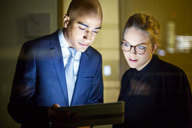 istock Businessman with colleague using digital tablet 646035466