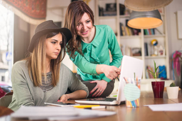 istock Female coworkers working together 646036384