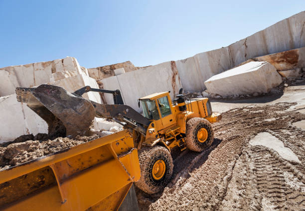 istock Excavator loading rubble stone to truck 646039958