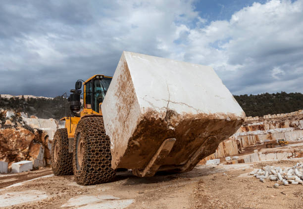 istock Bulldozer carrying block marble in quarry 646040680