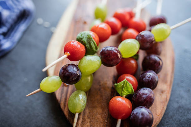 Fresh summer fruits on sticks. With mint leaves.