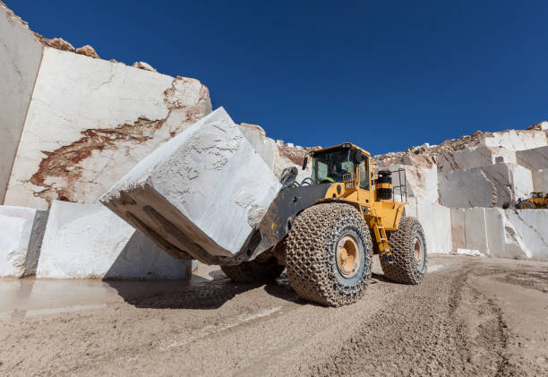 istock Bulldozer carrying block marble in quarry 646041018