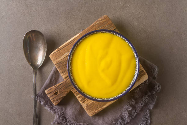 istock Smoothies yellow. Bread soup spoon. Gray background. 646043336