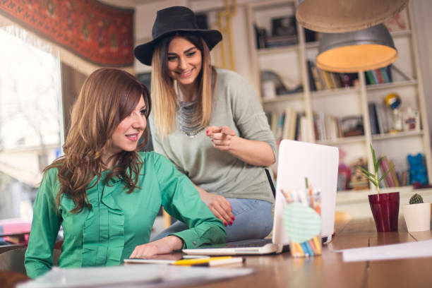 istock Female coworkers working together 646044006