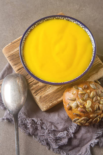 istock Smoothies yellow. Bread soup spoon. Gray background. 646044194