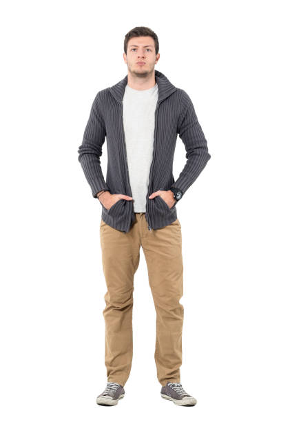 istock Serious man wearing sneakers and sweater with hands in pockets 646048022