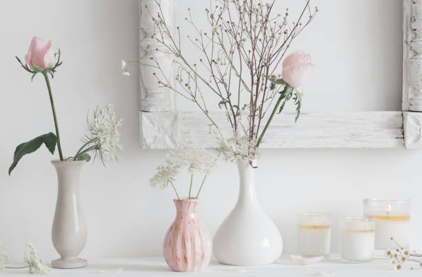 istock flowers in a vase and candles on white background 646048290