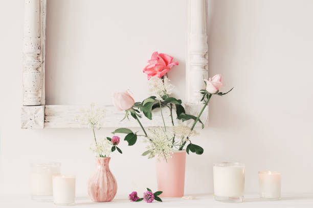 istock flowers in a vase and candles on white background 646048296