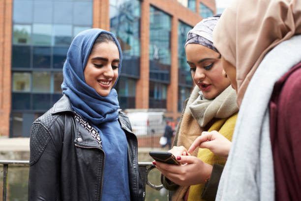 istock Muslim Female Friends Using Mobile Phone In Urban Setting 646051458