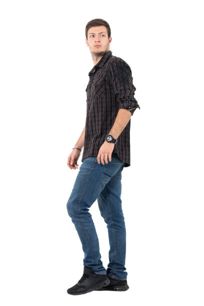 istock Side view of casual man walking looking back over shoulder 646052076