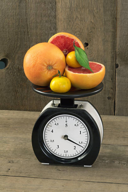 istock mandarins and grapefruit on the scales 646055354