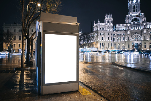 A bus stop with a blank billboard