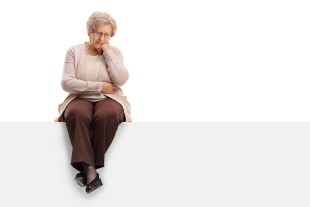 istock Pensive elderly woman sitting on a panel 646058216