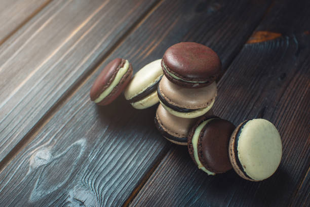 istock Coffee and chocolate macarons on a dark wooden table 646062206