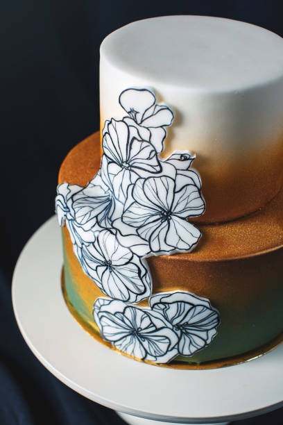 istock wedding cake decorated gold, green gradient with hand drawn flowers 646062270