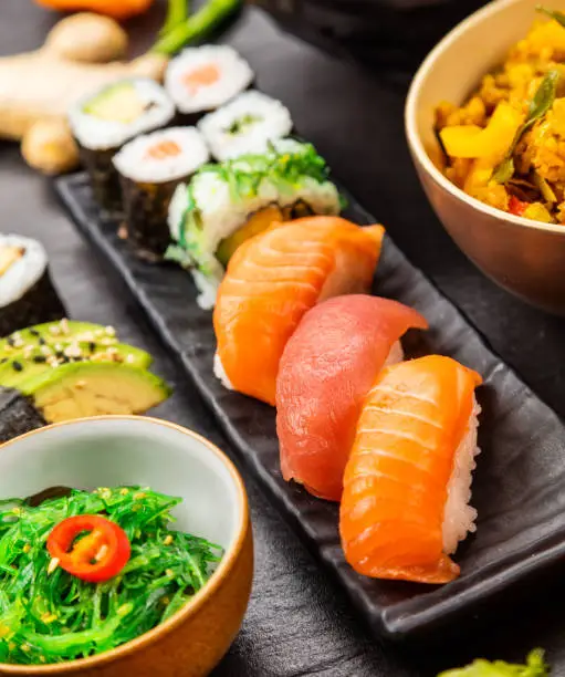 Japanese sushi pieces served on black stone