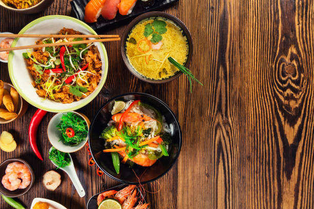 istock Asian food served on wooden table 646065340