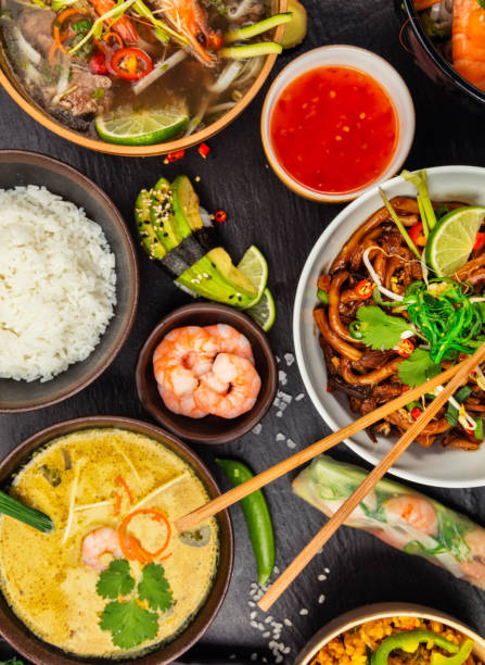 азиатская еда, подаваемая на черном камне, вид сверху - thai cuisine стоковые фото и изображения