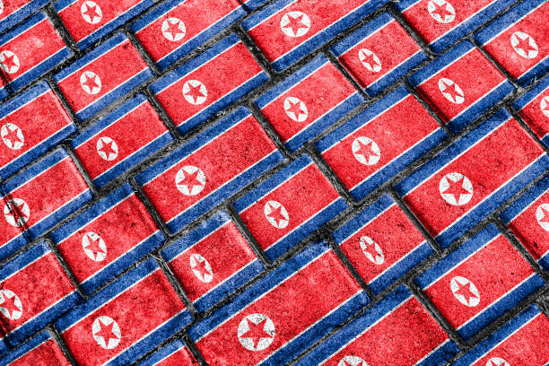 Pyongyang, North Korea - May 5, 2008: Detail of propagandistic decoration on office building at the Kim Il Sung Square in the centre of Pyongyang: North Korean flag and official portrait of the former president Kim Il Sung.