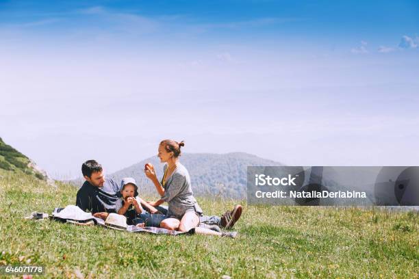 Beautiful Happy Family Spends Time On Nature In The Mountains Stock Photo - Download Image Now