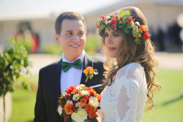 istock Lovely bride and groom smiling outside on the wedding day 646074842