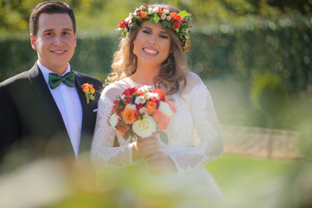istock Lovely bride and groom smiling outside on the wedding day 646080654