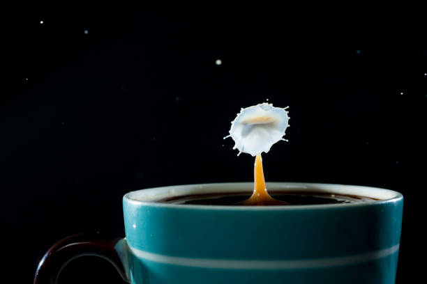 istock Milk drops splashing into a cup of coffee 646084392