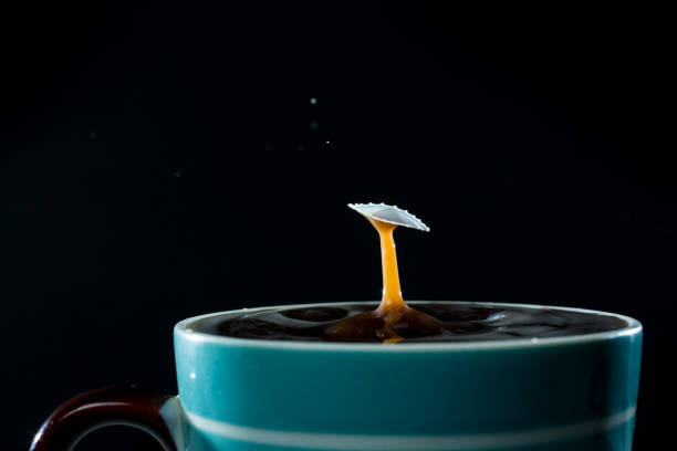 istock Milk drops splashing into a cup of coffee 646084434