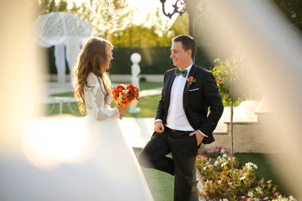 istock Lovely bride and groom smiling outside 646084484