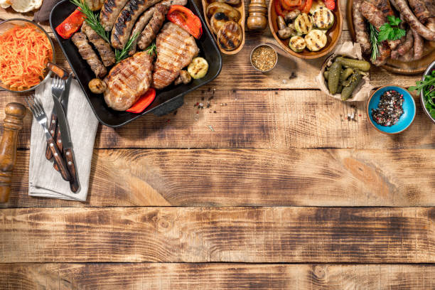 istock Different foods cooked on the grill on the wooden table with copy space 646085300