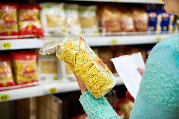 istock Woman with package pasta in shop 646088374