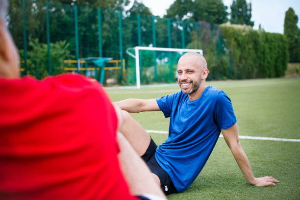 istock Senior soccer players taking rest after a match 646101418