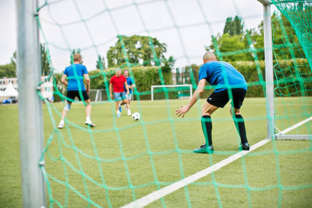 istock Seniors playing football on the field 646101870