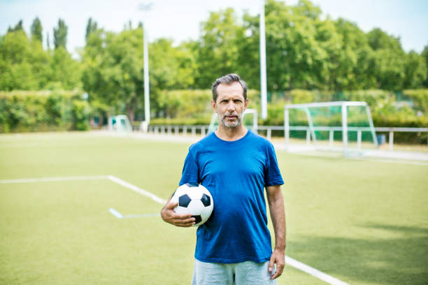istock Fit senior soccer player in blue jersey 646102190