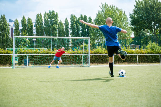 istock Senior men playing soccer on the field 646102450
