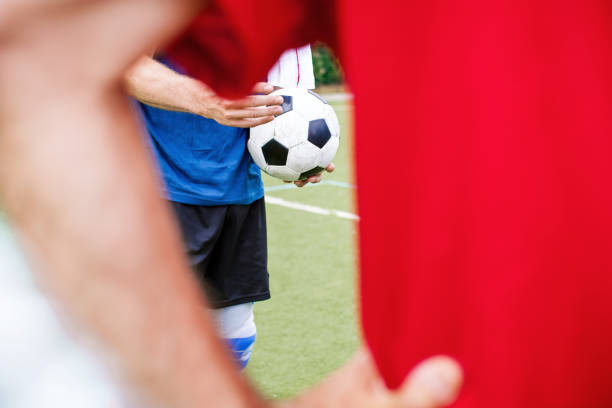 istock Senior men holding football before the game 646102642