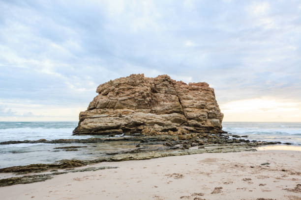 istock Big rock beach sunset long exposure 646106170