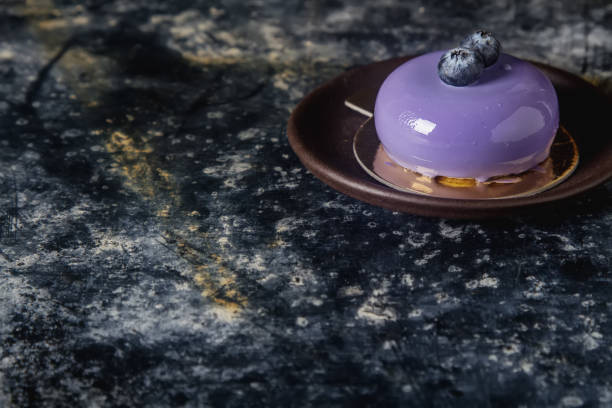 istock Trendy mousse cake with mirror glaze decorated. Dark background. 646106538