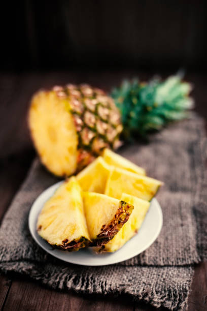 Pineapple tropical fruit / Ananas with slices over wooden table / Rustic, country Pineapple tropical fruit / Ananas with slices over wooden table / Rustic, country style ananas stock pictures, royalty-free photos & images
