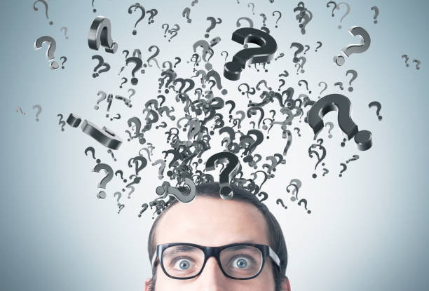 istock Close up of man with glasses and question marks 646109864