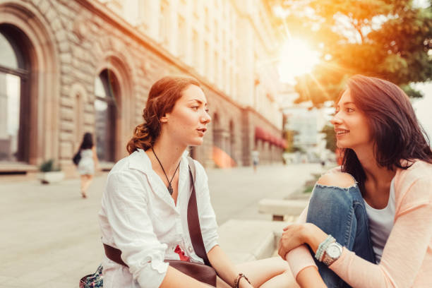 istock Young women gossiping outside 646110162