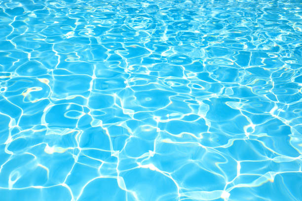 istock Blue water surface in swimming pool with sun reflection 646112924
