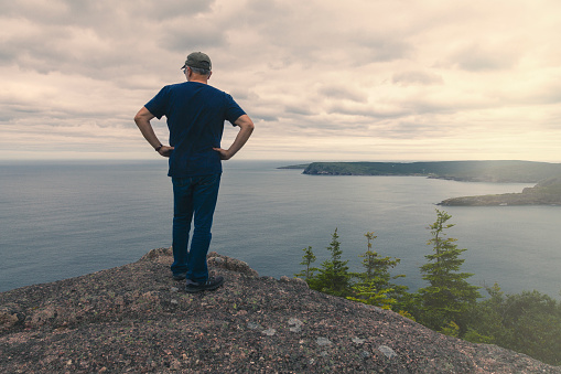 Middle aged man hiking the East Coast Trail in Newfoundland and Labrador, Canada