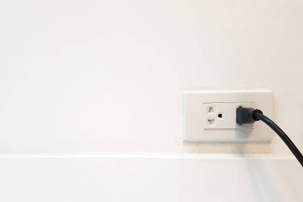 istock Electric cable in Electrical Outlet with ground wire on the Wall with copy space for label text. Power 250v 646113780
