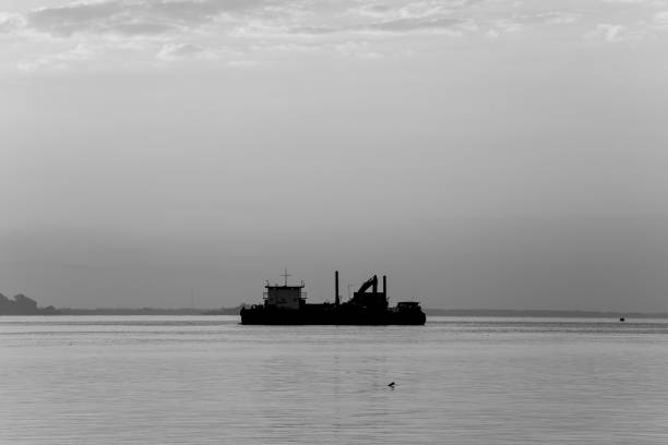 istock Cargo ship in the sea at dawn 646117996