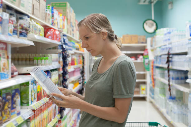 istock Young caucasian woman is watching into product composition 646120786