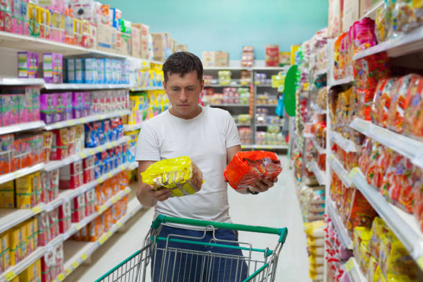 istock Young caucasian man make choose between two similar goods. 646120846