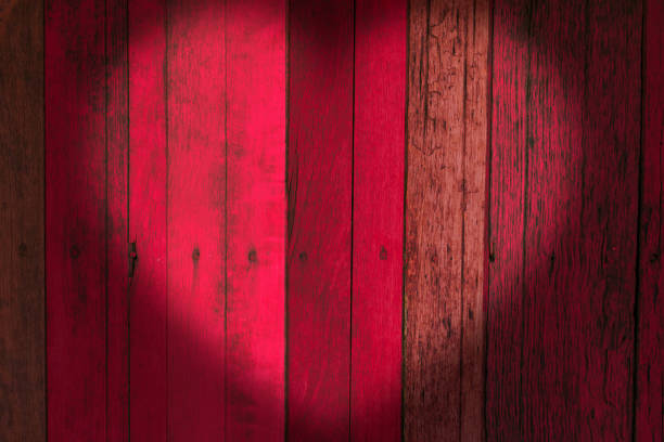 istock pink wooden wall with love heart shape shadow. 646131248