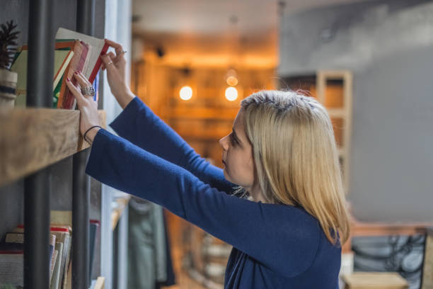 istock Young woman searching for a book 646132050